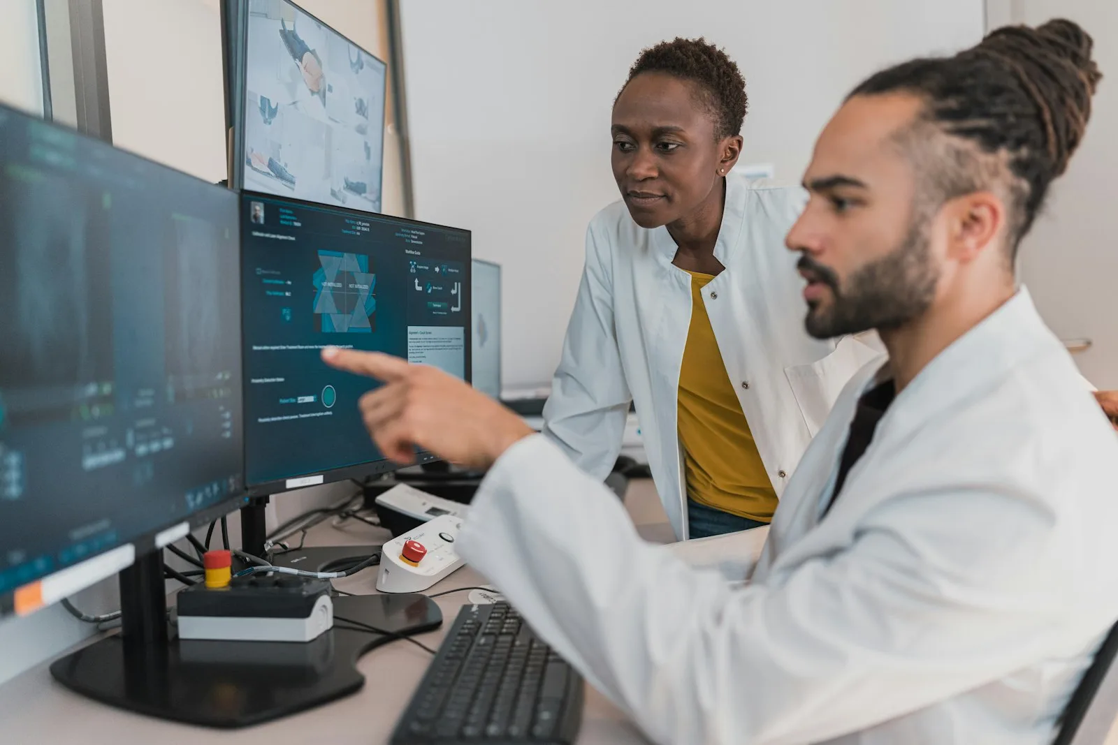 Two clinicians reviewing patient data on a digital diagnostics interface